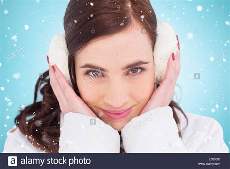 Composite Image Of Pretty Brunette With Ear Muffs Stock Photo Alamy