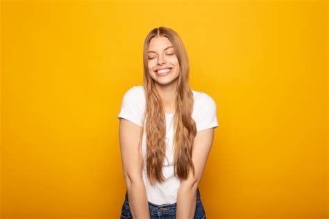Premium Photo Smiling Pretty Blonde Girl With Long Hair Isolated On Yellow