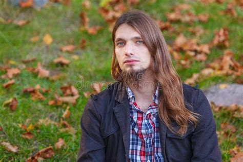 Man Long Hair Sitting On Bench In Autumn Park Stock Photo Image Of