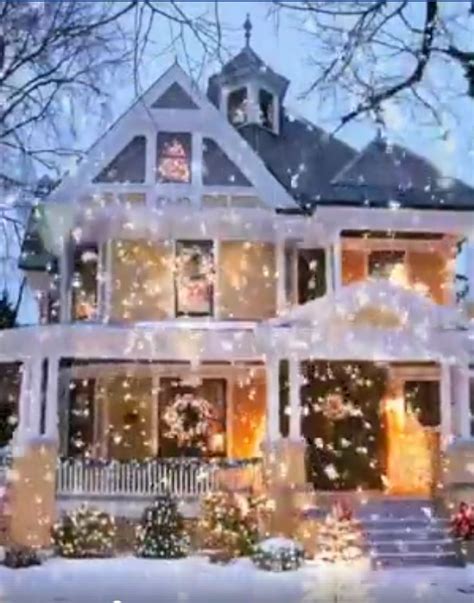 A Large White House Covered In Christmas Lights