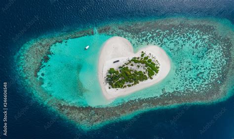 Drone Aerial View Of Beautiful Tropical Heart Shaped Island Among Blue