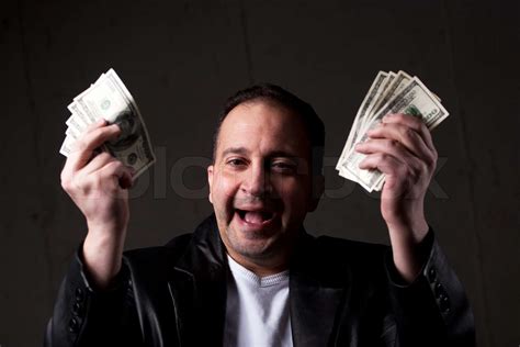 A Man Celebrating Holding Handfuls Of Green American Cash Money Shallow Depth Of Field With