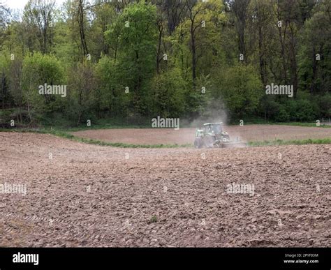 Arable Field Being Harrowed By Farm Tractor Stock Photo Alamy