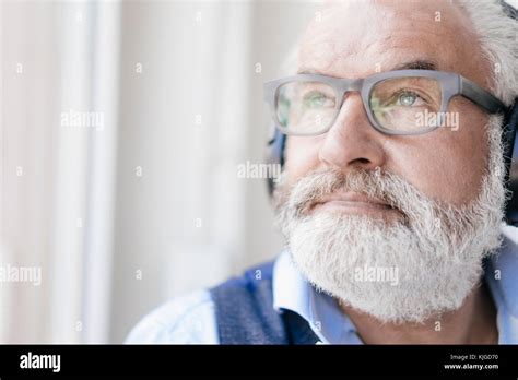 Mature Man Wearing Glasses And Headphones At The Window Stock Photo Alamy