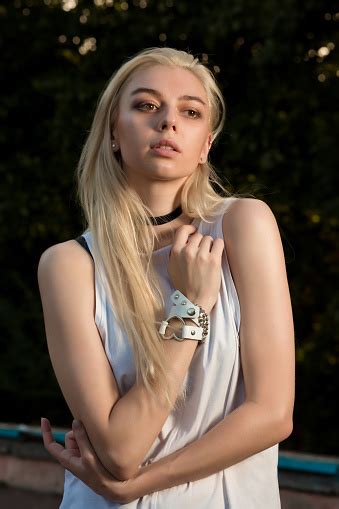 Amazing Blonde Girl With Long Hair Dressed In Fashionable Clothes And