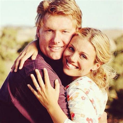 A Man And Woman Hugging Each Other In The Desert