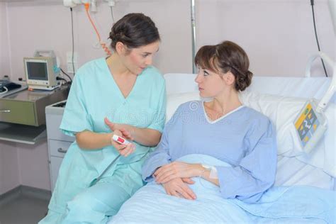 Nurse Talking To Patient in Hospital Bed Stock Image - Image of illness, adult: 258025901