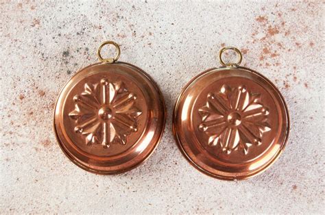 Premium Photo | Vintage copper molds on a concrete background.