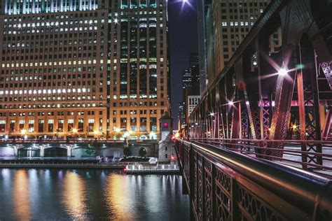 Brown And Black Concrete Building Near Body Of Water During Night Time Photo Free City Image