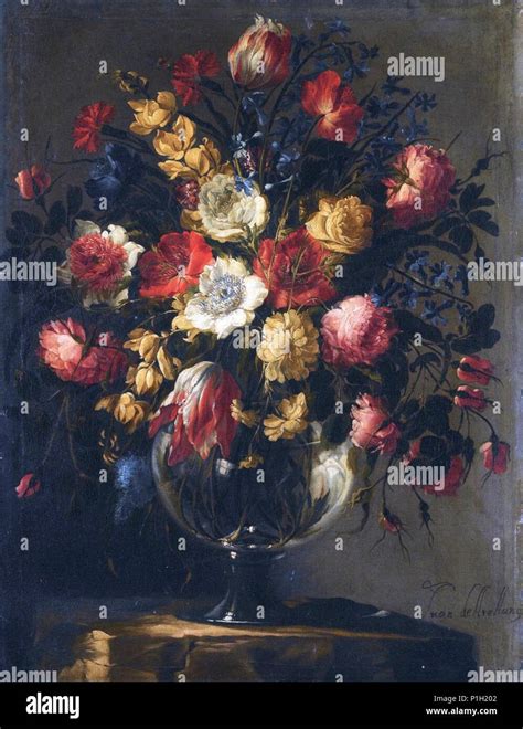 Still Life With A Large Array Of Flowers In A Glass Vase On A Stone