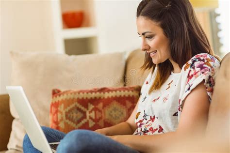 Pretty Brunette Relaxing On Couch With Laptop Stock Image Image Of Female Cheerful