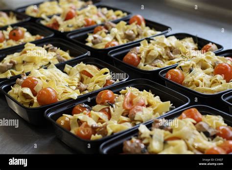 A Close Up Of Rows Of Pasta Salad In Plastic To Go Containers Stock