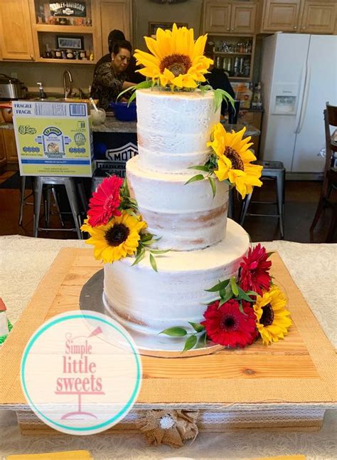 Naked Wedding Cake With Fresh Sunflowers And Gerber Daisies