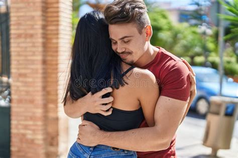 Man And Woman Couple Smiling Confident Hugging Each Other At Street