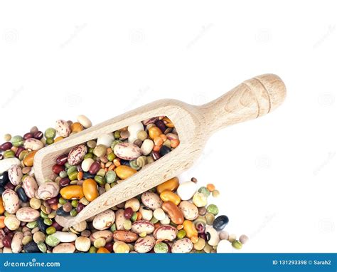 Assorted Dried Beans And Lentils With Wooden Scoop On White Background