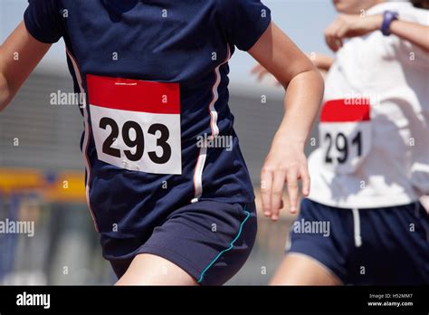 Male Runners Finalizing A Race In A Running Track Horizontal Stock