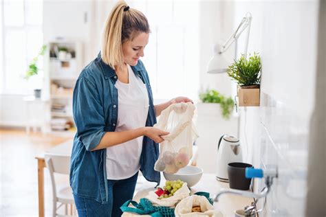 Young Woman With Fruit In Reusable Bag Indoors Sustainable Lifestyle