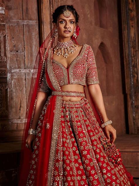 A Woman In A Red And Gold Bridal Gown