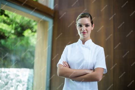 Premium Photo Portrait Of Confident Female Masseur Standing With Arms