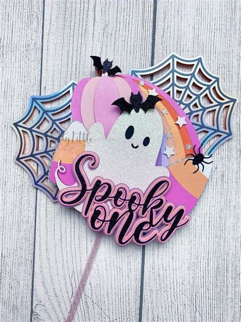 A Sticker With The Words Spooky On It And A Ghost Holding A Cupcake