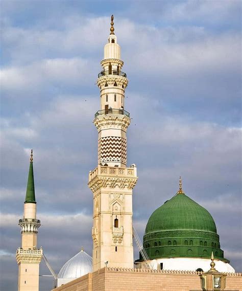 Download A Mosque With Two Green Domes And A Cloudy Sky | Wallpapers.com