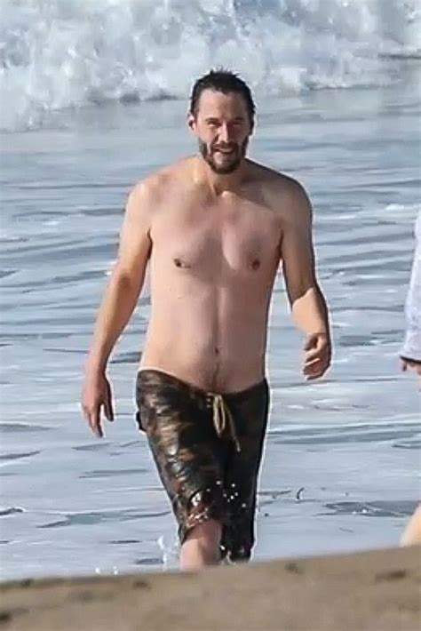 Hunky Keanu Reeves Reveals Trim Physique As He Strips Off For Swim