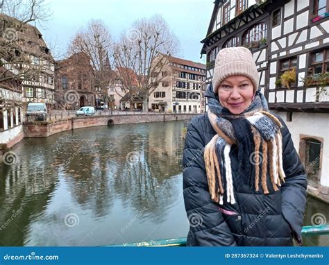Close Up Portrait Mature Woman At The Amazing Traditional Colorful Houses In La Petite France