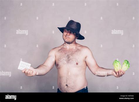 Naked Corpulent Man In Hat Giving Pharmaceutical Products And Lettuce