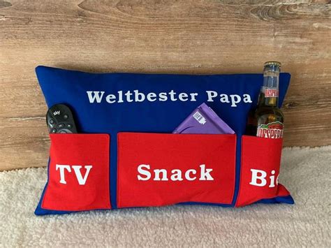 A Blue And Red Pillow With Two Beer Bottles In It That Says Weltbetter