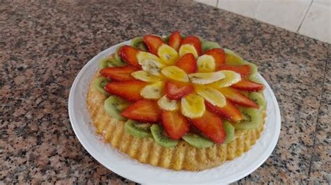 A Cake With Fruit On It Sitting On Top Of A Counter