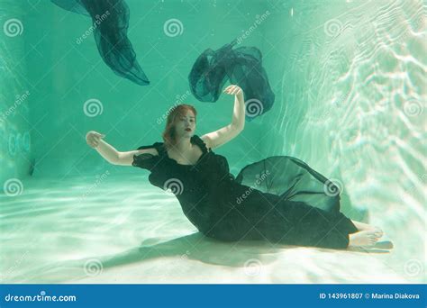 Hot Slim Woman Posing Under Water In Beautiful Clothes Alone In The Deep Stock Image Image Of