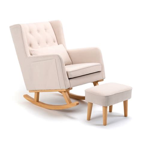 a white rocking chair and footstool next to each other on a white ...