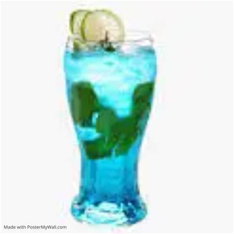 A Tall Glass Filled With Blue Liquid And Lime