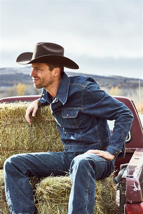 Cowboy Sitting On His Hay In The Back Of A Truck Del Colaborador De