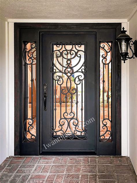 The Front Door Is Decorated With Wrought Iron Doors And Glass Panels