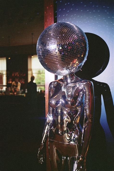 A Mirror Ball Head Disco Mannequin Prop At A Wedding Reception Room