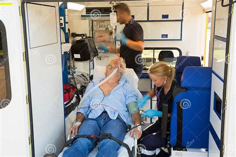 Paramedics Treating Unconscious Man In Ambulance Stock Photo Image Of