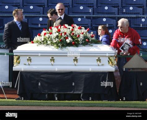 A Philadelphia Phillies Fan Reaches Over To Touch The Coffin Of Hall Of