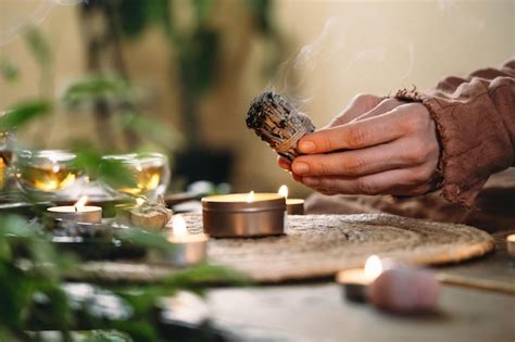 Premium Photo Woman Hands Burning White Sage Before Ritual On Cadle