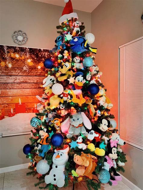 a christmas tree with many different stuffed animals on it and ...