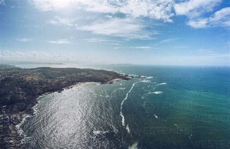 Aerial View Of Sea And Land Against Sky On Sunny Day Stock Photo