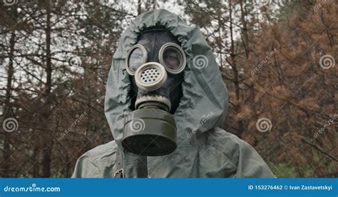 Man Wearing A WWII Hazmat Suit And Gas Mask Carrying A Counter In His ...