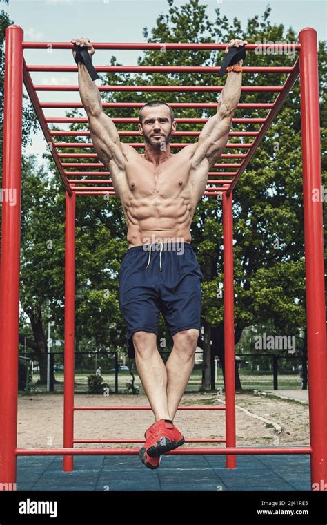 Muscular Man Doing Pull Ups On Horizontal Bar Stock Photo Alamy