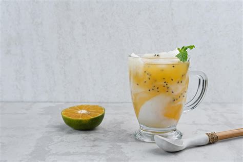 Es Kelapa Jeruk, a typical Indonesian drink made from fresh oranges squeezed with grated young ...