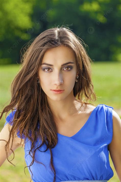 Summer Portrait Of A Beautiful Young Brunette Caucasian Girl In Blue