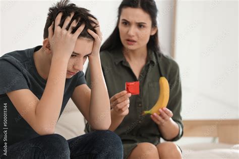Mother talking with her teenage son about contraception at home Sex education concept Stock 写真