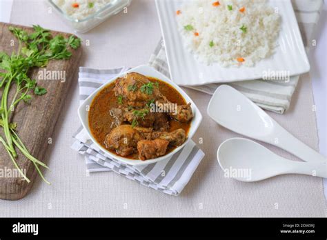 Chicken Masala Curry With Ghee Rice Or Biryani Rice Placed In A Square