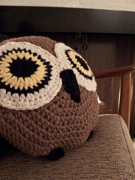 A Crocheted Owl Pillow Sitting On Top Of A Chair