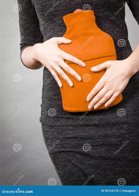 Woman Feeling Stomach Cramps Holding Hot Water Bottle Stock Photo