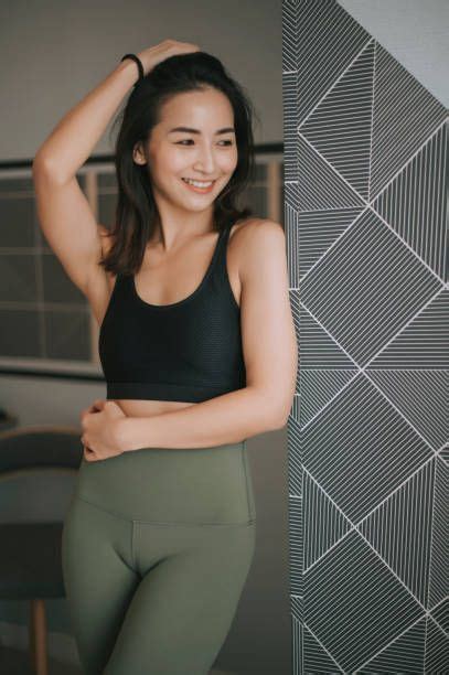 Asian Chinese Beautiful Woman With Yoga Pants And Sport Bra Beside